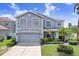 Charming two-story home with a well-maintained lawn, complemented by a paved driveway and lush landscaping at 7515 Dragon Fly Loop, Gibsonton, FL 33534