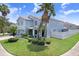 Exterior view of home with well maintained landscaping, backyard fence and lush green lawn under a bright blue sky at 7515 Dragon Fly Loop, Gibsonton, FL 33534