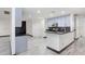 Open concept kitchen with breakfast bar, tile floors and stainless steel microwave at 7515 Dragon Fly Loop, Gibsonton, FL 33534