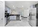 Modern kitchen with stainless steel appliances, light blue cabinets, and a sleek countertop, open to the living space at 7515 Dragon Fly Loop, Gibsonton, FL 33534