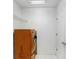 Bright laundry room featuring an eye-catching orange washer and dryer unit at 7515 Dragon Fly Loop, Gibsonton, FL 33534