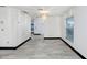 Well-lit living room featuring gray-toned flooring, neutral walls, and large windows allowing plenty of sunlight at 7515 Dragon Fly Loop, Gibsonton, FL 33534