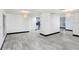 Spacious living room with new gray toned flooring, ample natural light, and minimalist modern light fixtures at 7515 Dragon Fly Loop, Gibsonton, FL 33534