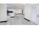 Open living room with gray tile flooring and stainless steel kitchen appliances at 7515 Dragon Fly Loop, Gibsonton, FL 33534