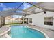 Lovely kidney-shaped pool situated inside a screened-in enclosure at 7515 Dragon Fly Loop, Gibsonton, FL 33534