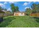 The house features a large backyard with a wood fence and mature trees offering lots of shade at 8606 N 9Th St, Tampa, FL 33604