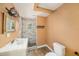 Well-lit bathroom featuring a tiled shower, modern vanity, and wood-look flooring at 8606 N 9Th St, Tampa, FL 33604