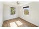 Bedroom features wood-look tile floors, neutral paint, and natural light at 8606 N 9Th St, Tampa, FL 33604