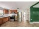 Galley kitchen with stainless steel appliances, wood cabinets, and wood-look tile flooring at 8606 N 9Th St, Tampa, FL 33604