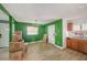 Bright, open-concept living space with wood-look tile flooring, neutral paint, and ample natural light at 8606 N 9Th St, Tampa, FL 33604
