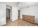 Main bedroom with hardwood floors, closet, ceiling fan, and ensuite bathroom at 8606 N 9Th St, Tampa, FL 33604