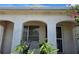 Charming home featuring an arched entryway with chairs on the porch, a security screen, and mature landscaping at 9505 Marlinton Ln, Port Richey, FL 34668