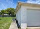 Home exterior featuring a one-car garage, well-maintained siding, and a grassy backyard at 9505 Marlinton Ln, Port Richey, FL 34668