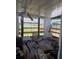 Enclosed patio featuring a ceiling fan, patio furniture, and window coverings for added privacy at 9505 Marlinton Ln, Port Richey, FL 34668