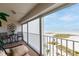 Relaxing balcony area with comfortable seating, offering stunning views of the beach and the ocean at 11000 Gulf Blvd # 1004, Treasure Island, FL 33706