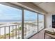 Balcony with panoramic views of the pristine white sand beach and the serene ocean at 11000 Gulf Blvd # 1004, Treasure Island, FL 33706
