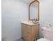 Compact bathroom with a marble vanity, wood-look cabinets, and a clean, functional design at 11000 Gulf Blvd # 1004, Treasure Island, FL 33706