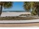 Scenic view of the beach, framed by palm trees and a sunny sky at 11000 Gulf Blvd # 1004, Treasure Island, FL 33706