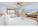 Spacious bedroom with dual beds, a TV, and balcony access, creating a relaxing coastal retreat at 11000 Gulf Blvd # 1004, Treasure Island, FL 33706
