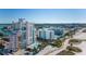 An aerial view shows the building near the bay, beach and local area at 11000 Gulf Blvd # 1004, Treasure Island, FL 33706