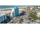 An aerial view showing the building near local shops, white sandy beaches, and neighborhood at 11000 Gulf Blvd # 1004, Treasure Island, FL 33706