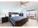 Serene main bedroom with a king-size bed, dark wood furniture, and access to a private balcony at 11000 Gulf Blvd # 1004, Treasure Island, FL 33706