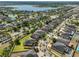 Beautiful aerial view of neighborhood with lake, well-manicured lawns, and mature trees at 11044 Spring Point Cir, Riverview, FL 33579