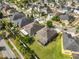 An aerial view of a residential neighborhood showcases well-maintained homes and verdant landscaping at 11044 Spring Point Cir, Riverview, FL 33579