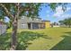 Large backyard showing screened patio, perfect for outdoor entertainment and relaxation at 11044 Spring Point Cir, Riverview, FL 33579
