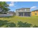 A spacious backyard features a screened patio, offering an ideal outdoor living space at 11044 Spring Point Cir, Riverview, FL 33579