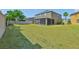 A sizable lawn and screened lanai make this backyard an outdoor paradise at 11044 Spring Point Cir, Riverview, FL 33579