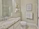 Tidy bathroom features a vanity with granite countertop, framed art, and tiled shower at 11044 Spring Point Cir, Riverview, FL 33579