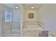 Elegant bathroom featuring a separate glass shower, soaking tub, and refined finishes for a spa-like experience at 11044 Spring Point Cir, Riverview, FL 33579