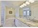 Luxurious bathroom with a soaking tub, granite counters, a walk-in shower, and ample space for relaxation at 11044 Spring Point Cir, Riverview, FL 33579