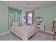 Comfortable bedroom featuring light green walls, soft carpet flooring, and a bright window at 11044 Spring Point Cir, Riverview, FL 33579