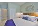 Bright bedroom with accent mirror, decorative lamps, and view of adjacent doorway at 11044 Spring Point Cir, Riverview, FL 33579