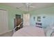 Bedroom featuring a double door closet, green walls, light carpet flooring, and an airy feel at 11044 Spring Point Cir, Riverview, FL 33579