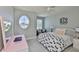 Bright bedroom with a cozy décor, unique window, and ample space, perfect for relaxation or study at 11044 Spring Point Cir, Riverview, FL 33579