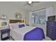 Stylized bedroom features a wood headboard, bright white bedding, and plenty of natural light at 11044 Spring Point Cir, Riverview, FL 33579
