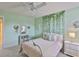 Comfortable bedroom featuring light green walls, and a view of decorative wall ivy at 11044 Spring Point Cir, Riverview, FL 33579