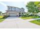 Well-maintained two-story home boasts a lush green lawn and a neatly paved driveway at 11044 Spring Point Cir, Riverview, FL 33579