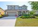 Charming two-story home features a manicured front yard, stone accents, and a two-car garage at 11044 Spring Point Cir, Riverview, FL 33579