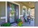 Inviting front porch with decorative wreath, seating, and colorful plants adds to the curb appeal at 11044 Spring Point Cir, Riverview, FL 33579