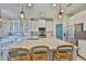 Kitchen features a granite island with seating, white cabinets, and stainless steel appliances at 11044 Spring Point Cir, Riverview, FL 33579