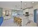 Kitchen with a granite island, seating, and stainless steel appliances next to a dining area at 11044 Spring Point Cir, Riverview, FL 33579