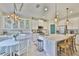 Bright kitchen with white cabinets, granite counters, stainless appliances, and an island with breakfast bar seating at 11044 Spring Point Cir, Riverview, FL 33579