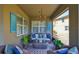 Charming covered lanai featuring a comfortable sofa, accent pillows, and bright décor for a welcoming outdoor space at 11044 Spring Point Cir, Riverview, FL 33579
