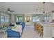 Spacious living area boasts a comfortable blue sofa, decorative curtains, and seamless flow at 11044 Spring Point Cir, Riverview, FL 33579