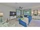 Living room with a large window for natural light, a plush sofa, and a wall-mounted television at 11044 Spring Point Cir, Riverview, FL 33579