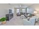 Spacious living room features modern furniture, neutral walls, plush carpet, and a ceiling fan at 11044 Spring Point Cir, Riverview, FL 33579
